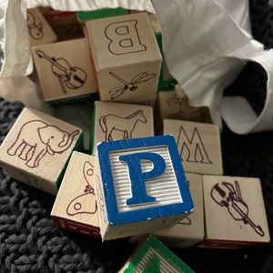 Melissa and Doug bag of wooden alphabet and number blocks.